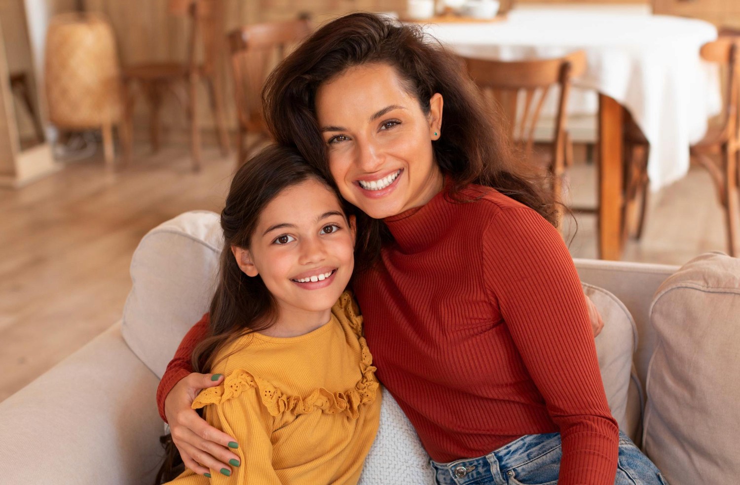 Mother and daughter smiling together.